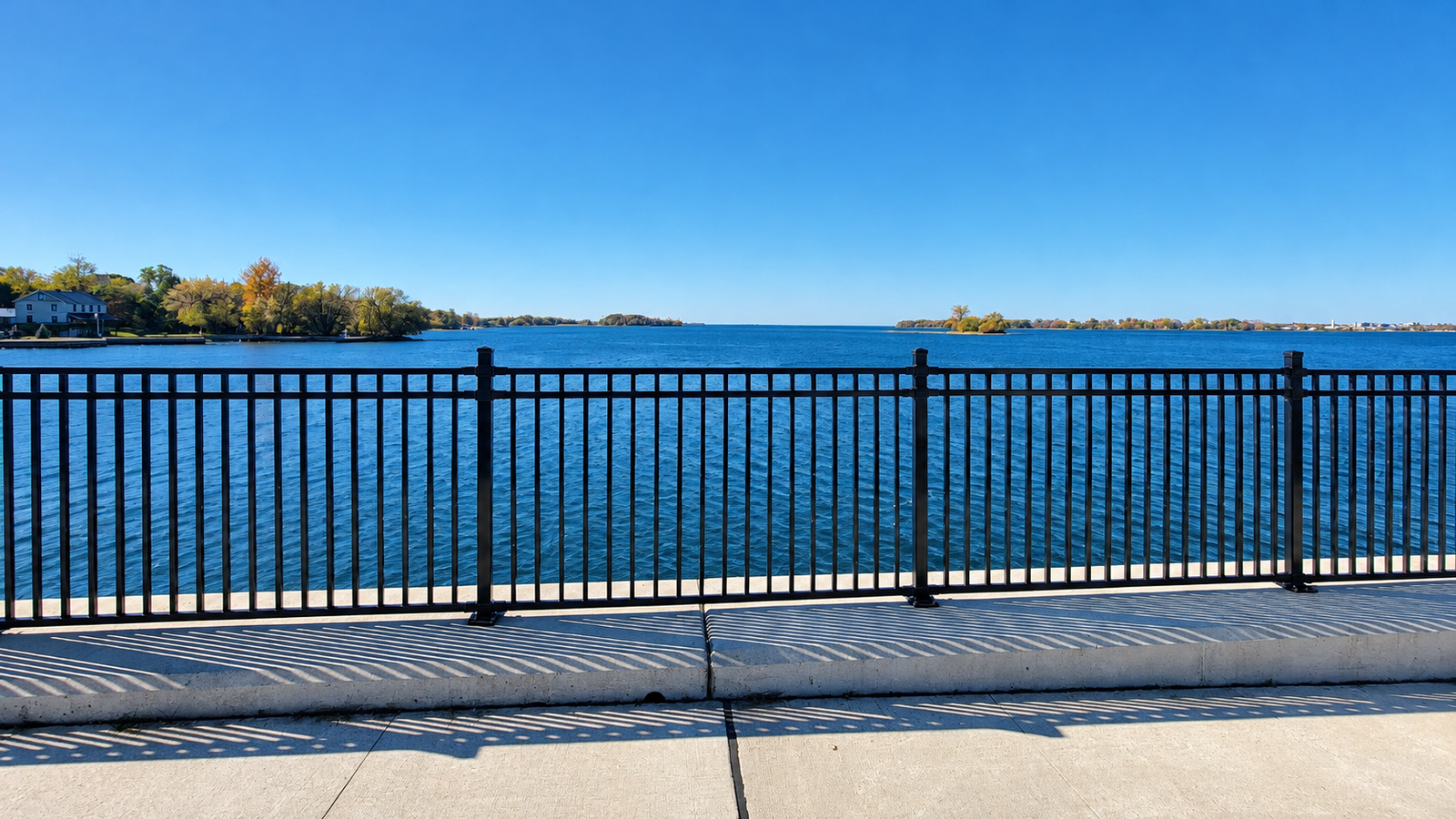 Waterfront promenade with clear blue water